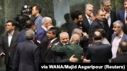 Ismail Haniyeh embraces Hossein Salami, the chief commander of the Islamic Revolutionary Guards Corps (IRGC), in the Iranian parliament during Pezeshkian's inauguration on July 30.