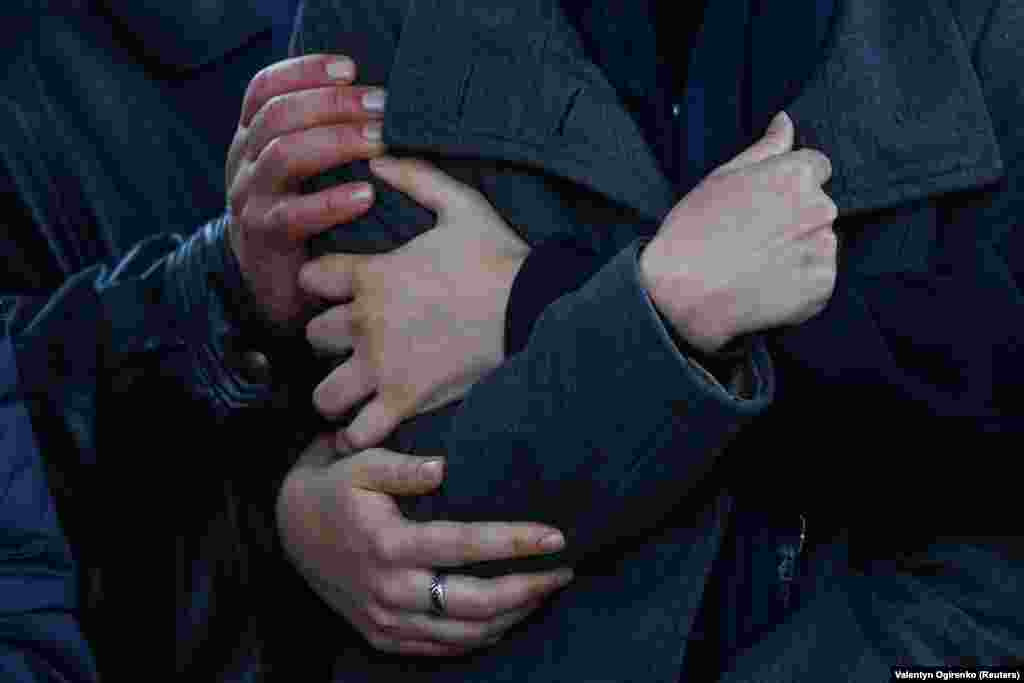 Friends support a woman during a funeral ceremony for her boyfriend, a Ukrainian soldier who was killed fighting Russian troops in the Zaporizhzhya region, during a funeral ceremony on Independence Square in Kyiv on November 7.