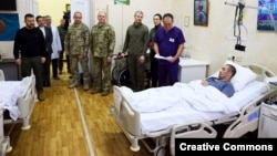 Ukrainian President Volodymyr Zelenskiy (left) visits wounded soldiers at a hospital in Kyiv on December 6.