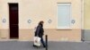 A woman walks past a building tagged with Stars of David in Paris on October 31.