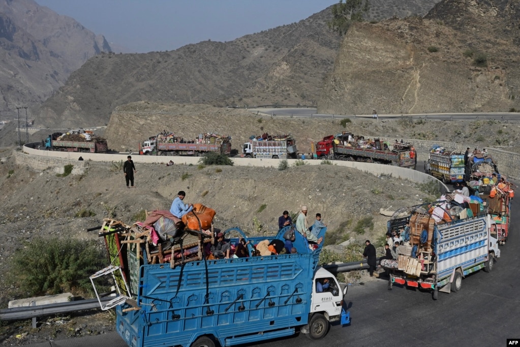 Trucks transporting Afghan refugees with their belongings travel a road toward the Pakistan-Afghanistan Torkham border crossing on November 3, 2023, following Pakistan's government decision to expel people illegally staying in the country.