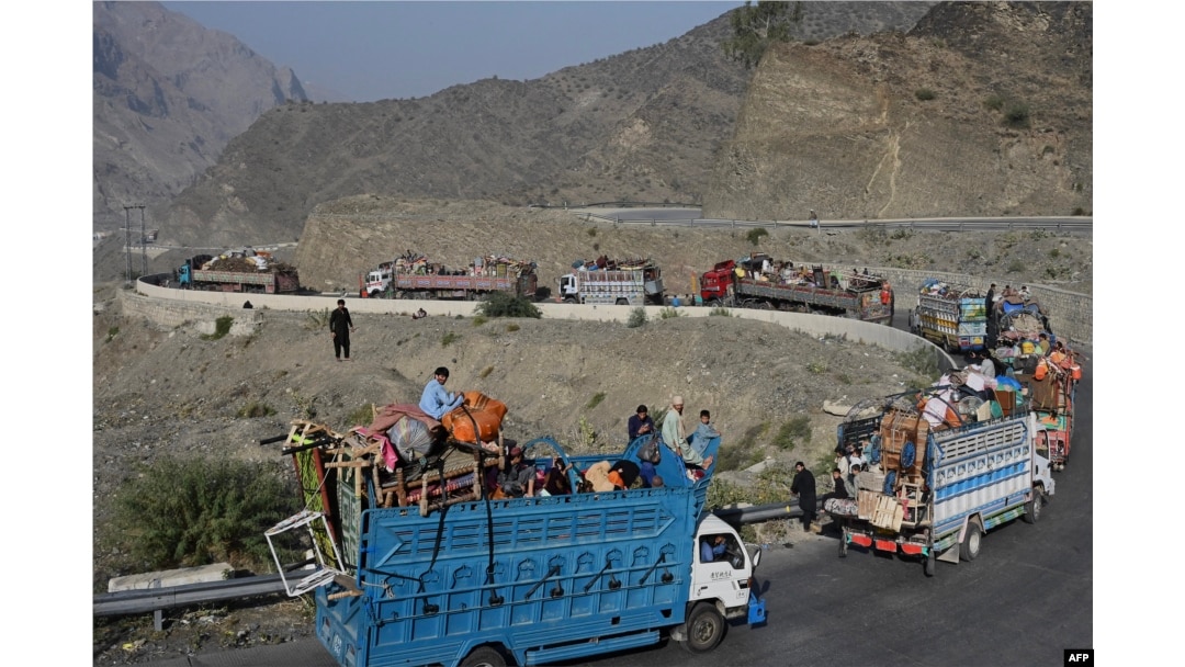 Trucks transporting Afghan refugees with their belongings travel a road toward the Pakistan-Afghanistan Torkham border crossing on November 3, 2023, following Pakistan's government decision to expel people illegally staying in the country.