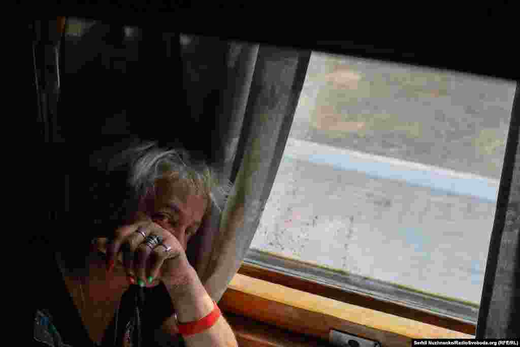 A woman struggles to hold back her tears aboard the evacuation train.