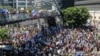 Israel - Families and supporters of Israeli hostages held by Palestinian militants in the Gaza Strip since October lift flags and placards during a rally calling for their release in Tel Aviv on September 2, 2024