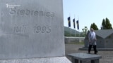 Potocari, Srebrenica, Bosnia and Herzegovina, Fadila Efendic approaches her son's and husband's grave 