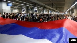 Protesters block the tracks at Belgrade's main railway station on August 10 to protest the government's plan to reboot the Rio Tinto lithium-mine project.