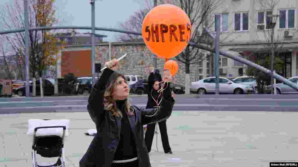 A demonstrator holds a balloon inscribed with the word &quot;Hope.&quot;