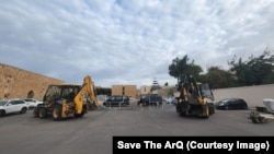 Diggers reportedly hired by XANA Capital are parked alongside a barrier set up by Jerusalem Armenians.