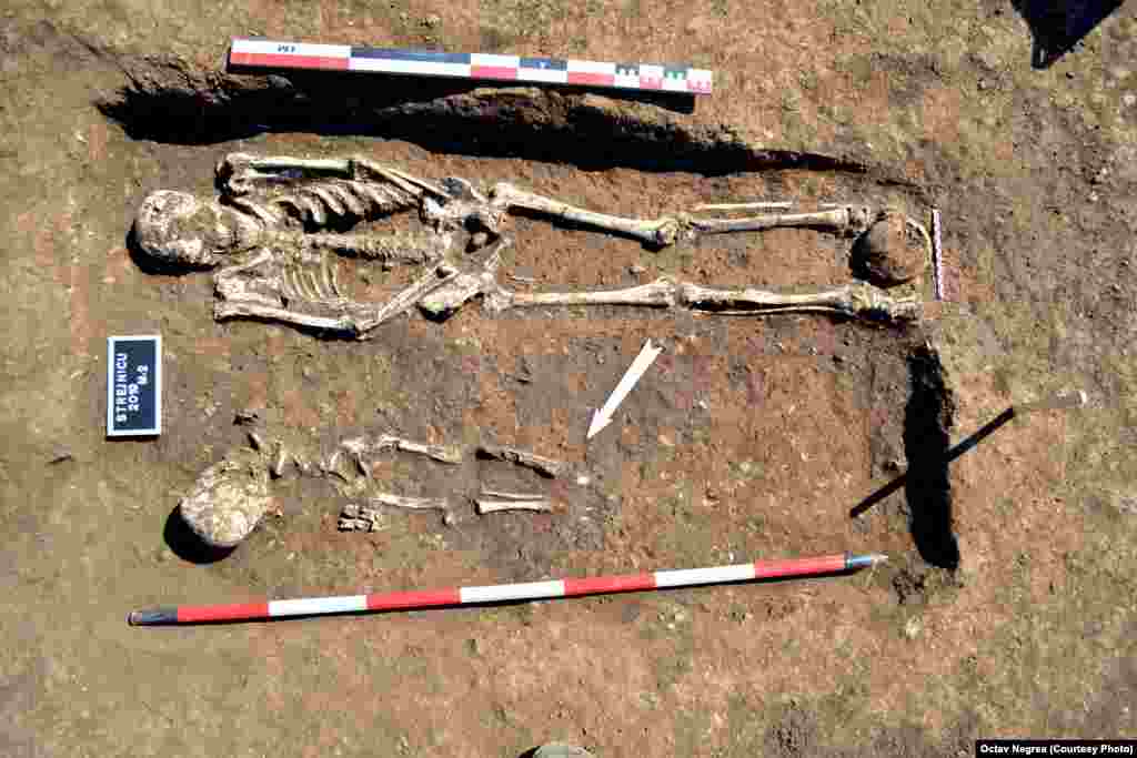 Archaeologists have discovered more than 40 burial mounds in which 200 people were buried, including this grave of an adult and a child. They were discovered under a tumulus&nbsp;-- a mound of earth or stone, conical or pyramidal in shape, raised above the grave for the purpose of protection. &nbsp;