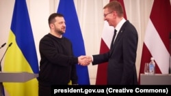 Ukrainian President Volodymyr Zelenskiy (left) meets his Latvian counterpart, Edgars Rinkevichs. in Riga on January 11. 