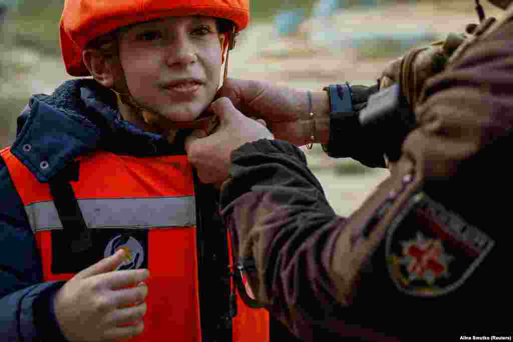 Denys, an 11-year-old from the town of Toretsk, has his helmet removed by a member of the special police unit known as the White Angels after he was brought to safety in the city of Kostyantynivka, Donetsk region, on November 13. Located some 7 kilometers from the front line, Kostyantynivka is the first port of call for many civilians fleeing the war in eastern Ukraine. &nbsp;
