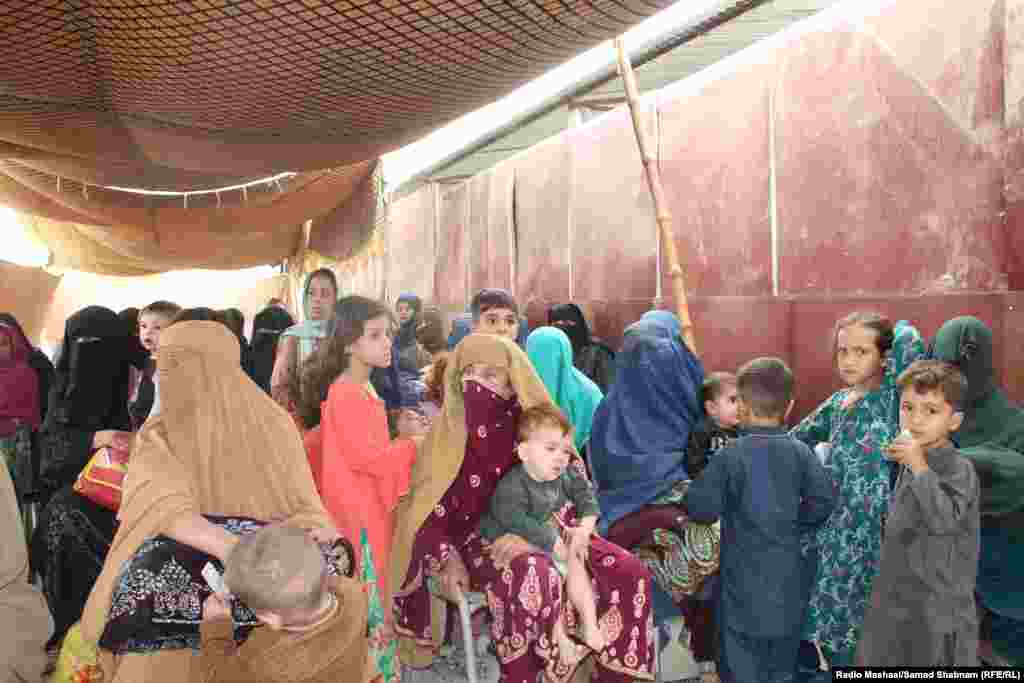 Afghan women and children wait at the center. Aid agencies warned that the mass movement of people could tip Afghanistan into yet another crisis and expressed &quot;grave concerns&quot; about the survival and reintegration of the returnees, particularly with the onset of winter.
