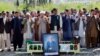 Relatives and mourners attend the funeral prayer for female field hockey player Shahida Raza, who died in a shipwreck last month. 