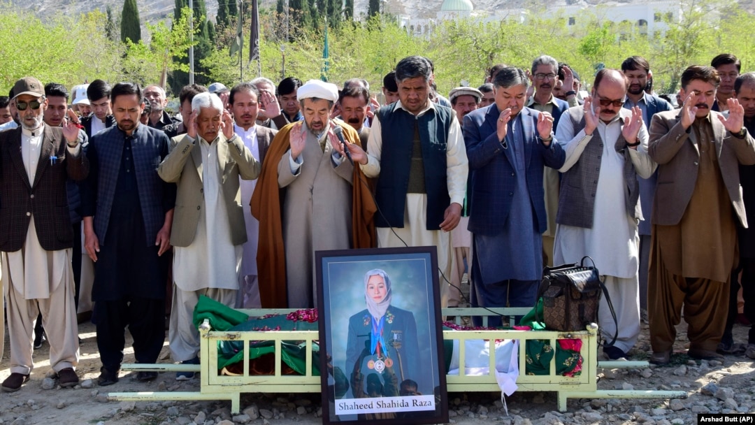 Relatives and mourners attend the funeral prayer for female field hockey player Shahida Raza, who died in a shipwreck last month. 