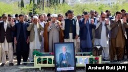 Relatives and mourners attend the funeral prayer for female field hockey player Shahida Raza, who died in a shipwreck last month. 