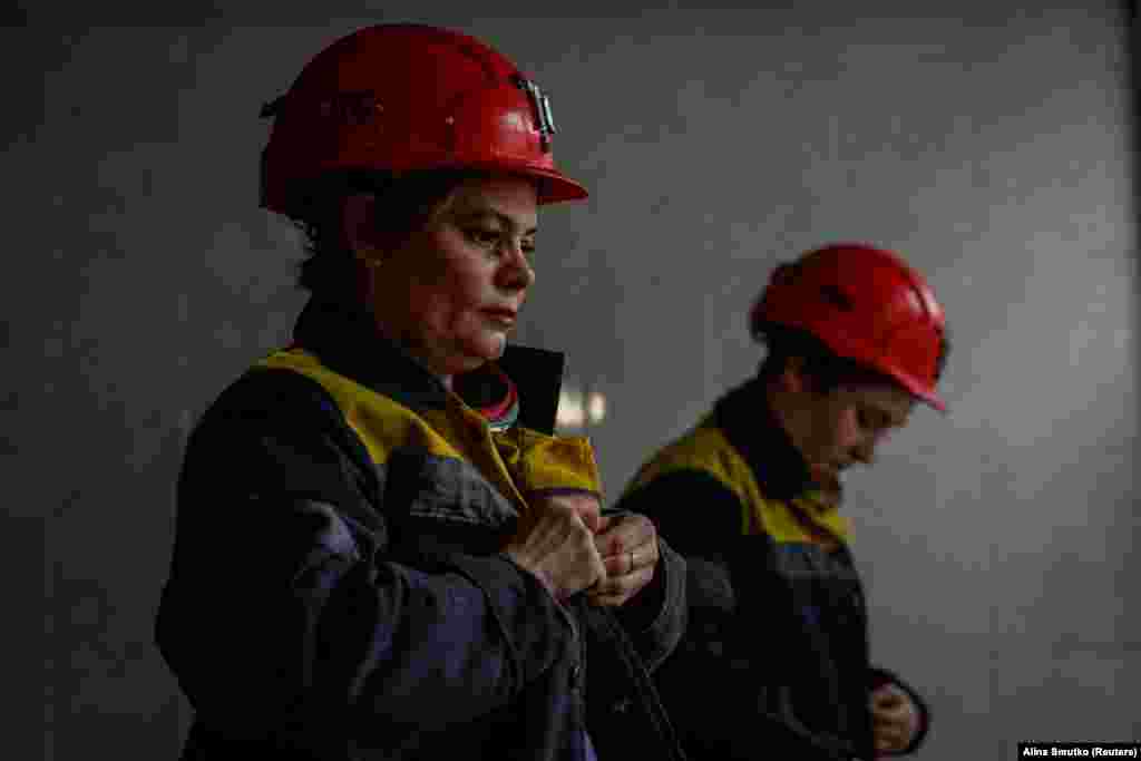 Natalya, 43, and Krystyna, 22, prepare for their shift deep underground at an undisclosed coal mine in the Dnipropetrovsk region on November 17. Around 1,000 men who previously worked at this mine are now serving on the front lines; 42 have been killed. Facing a staff shortage, the mine for the first time in its history has allowed women to work underground.