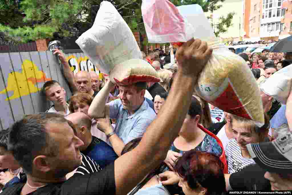 Local residents receive humanitarian aid outside the Russian town of Sudzha amid a cross-border incursion by Ukrainian forces.&nbsp;