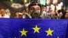GEORGIA – A demonstrator holds a flag of the European Union during a protest against a bill on "foreign agents" in Tbilisi, Georgia, May 1, 2024