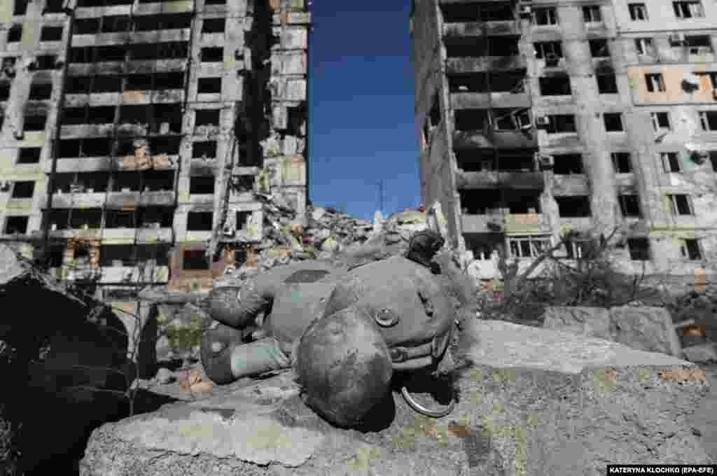 A stuffed animal toy lies in front of damaged residential buildings in Orikhiv, near the front line in Ukraine&#39;s southeastern Zaporizhzhya region.