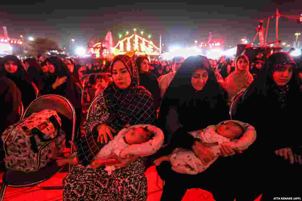  Women sit carrying infants as they attend the Moharram Shahr exhibition, ahead of commemorations marking the end of the 40-day mourning period for the 7th-century killing of the Prophet Muhammad&#39;s grandson, Imam Hussein ibn Ali, on Azadi Square in Tehran. &nbsp; 