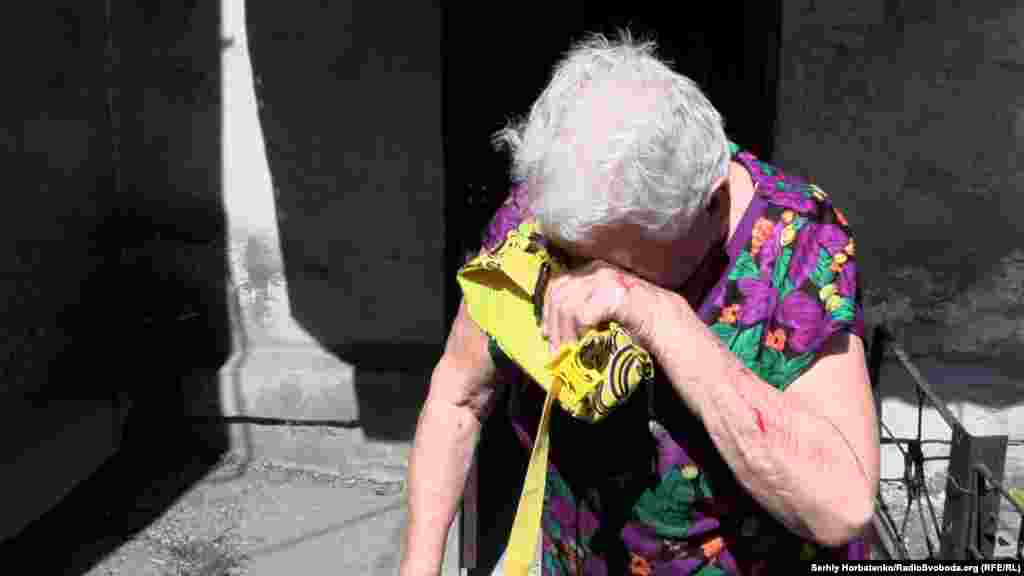 A Ukrainian woman pauses while overcome with emotion as the town of&nbsp;Myrnohrad, Donetsk region, is evacuated.