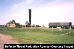 A missile being extracted from a silo in Ukraine. On the left is a bunker topped with an armored machine-gun nest. The bunker was designed to be a last-ditch defense of the formerly secret site.