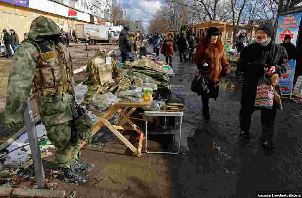 People shop at a makeshift market in Mariupol.&nbsp;