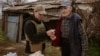 Olga Solarz brings supplies to Mykhaylo, who was the last person left in his village, until he passed away.