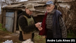 Olga Solarz brings supplies to Mykhaylo, who was the last person left in his village, until he passed away.