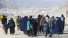 Afghan refugee families arrive on foot to cross the Pakistan-Afghanistan border at Torkham on November 2.