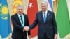 Uzbek President Shavkat Mirziyoev (left) shakes hands with Kazakh President Qasym-Zhomart Toqaev in Astana on November 3.