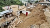 Residents gather at the site of a landslide in the remote area of Patrak in the Upper Dir district of Pakistan&#39;s Khyber Pakhtunkhwa Province on August 30.<br />
<br />
Twelve people died on August 30 when a landslide triggered by heavy rains destroyed their house, rescue officials said, with more than 300 killed since the start of the monsoon season.