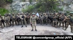 On May 10, Prigozhin stood with Wagner mercenaries while filming a video threat to pull his fighters out of Bakhmut, citing ammunition shortages.