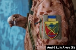Ihor, a soldier wounded fighting in Avdiyivka, wears a patch of the city on his shoulder.