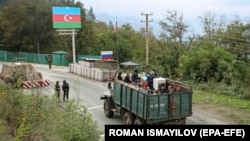 Ethnic Armenian flee Karabakh for Armenia sitting in a truck at the Lachin checkpoint controlled by Russian peackeepers and Azeri border guards, 26 September 2023.