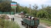 Ethnic Armenians flee Karabakh for Armenia sitting in a truck at the Lachin checkpoint controlled by Russian peackeepers and Azeri border guards, 26 September 2023. 