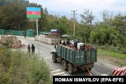 Ethnic Armenians flee Nagorno-Karabakh for Armenia in a truck at the Lachin checkpoint controlled by Russian peacekeepers and Azerbaijani border guards in September 2023.