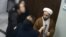 ویدئویی که روز شنبه در شبکه‌های اجتماعی منتشر شد، نشان می‌داد یک فرد معمم در یک مرکز درمانی از زنی (نفر سمت چپ) که بدون حجاب اجباری کودکی را در آغوش گرفته فیلمبرداری می‌کند
