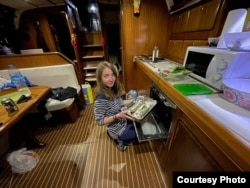 Ksenia cooking inside the yacht.