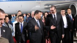 Chinese President Xi Jinping and Serbian leader Aleksandar Vucic meet at the airport late on May 7.