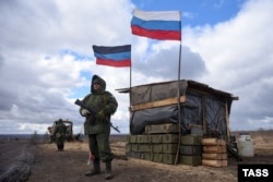 Police from the Donetsk People's Republic man a checkpoint in Russian-occupied territory of Ukraine on March 27, 2022.