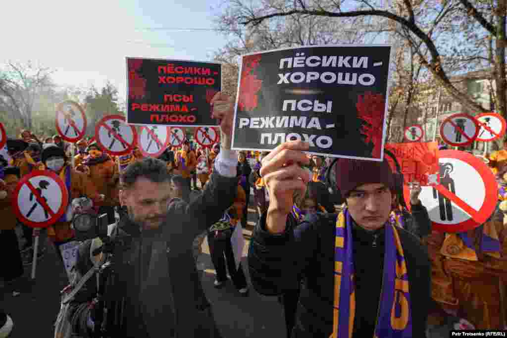 During the rally two men held up signs that say, &quot;Dogs are good, the regime&#39;s lapdogs are bad.&quot; The two activists from the KazLeft, a leftist movement in Kazakhstan, said they were protesting against the government&#39;s use of torture and the shooting of protesters. &quot;Our signs fit the theme of today&#39;s rally,&quot; said a young man who called himself Ilyas.&nbsp;The activists were warned about the content of their posters but were not removed.