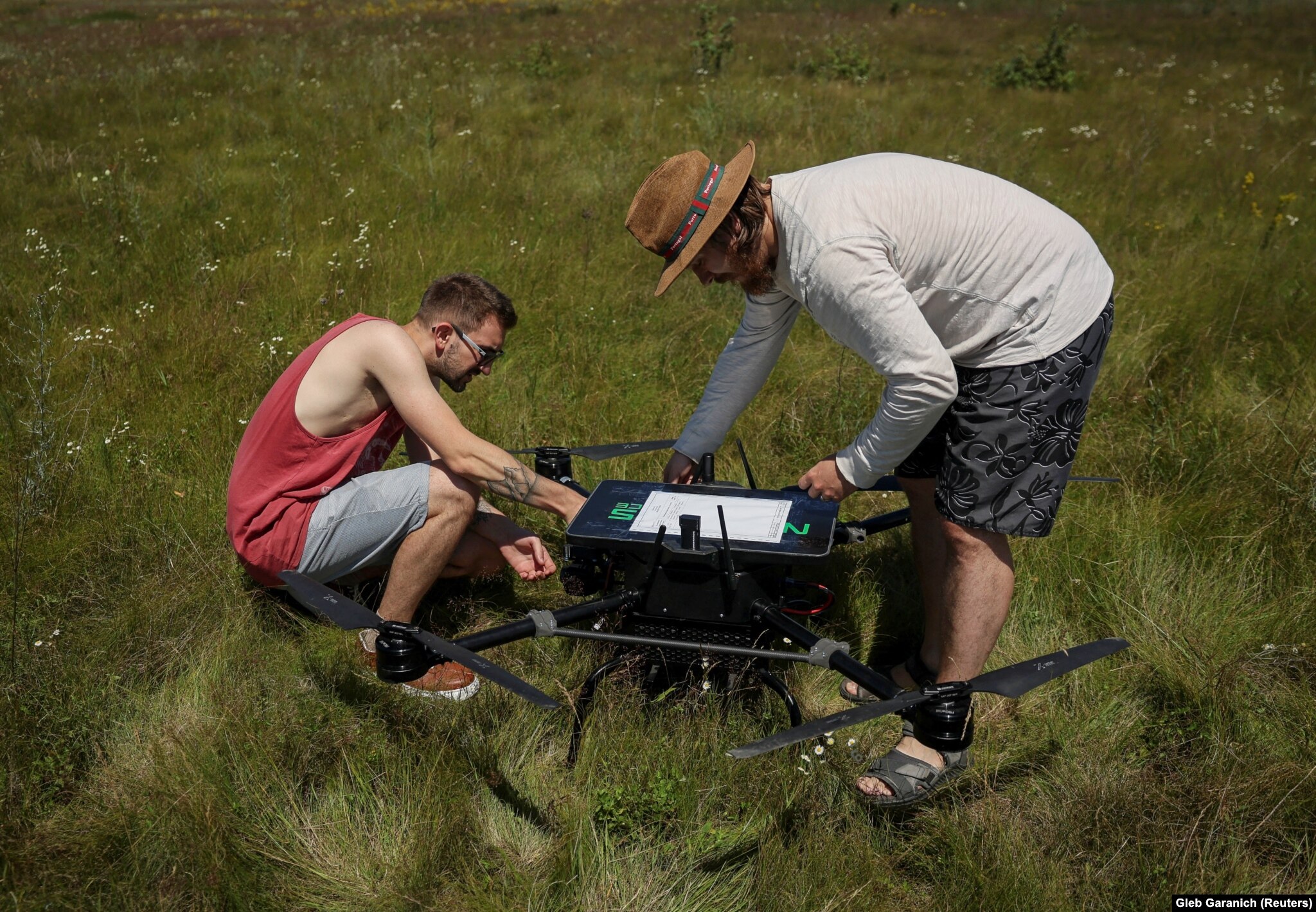 Employees of Ukraine's Swarmer drone company prepare an AI-enabled quadcopter for flight in the Kyiv region in June.
