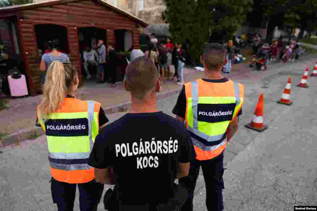 Refugees, under the watch of civil guards, set up camp near a bus station after being evicted from their temporary accommodation. &nbsp;