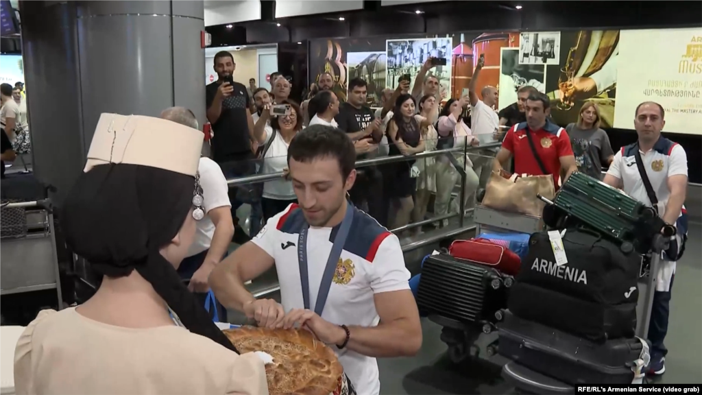 Fans turn our to welcome to the Armenian men&#39;s gymnastics team at Zvartnots airport after their return from the Olympic Games on August 8. Armenia took home a silver and bronze medal in Greco-Roman wrestling and a silver medal in artistic gymnastics.