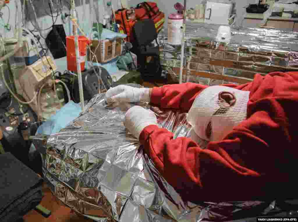 An injured man is treated by military doctors at a stabilization point near the front line in Ukraine&#39;s eastern Donetsk region.&nbsp;