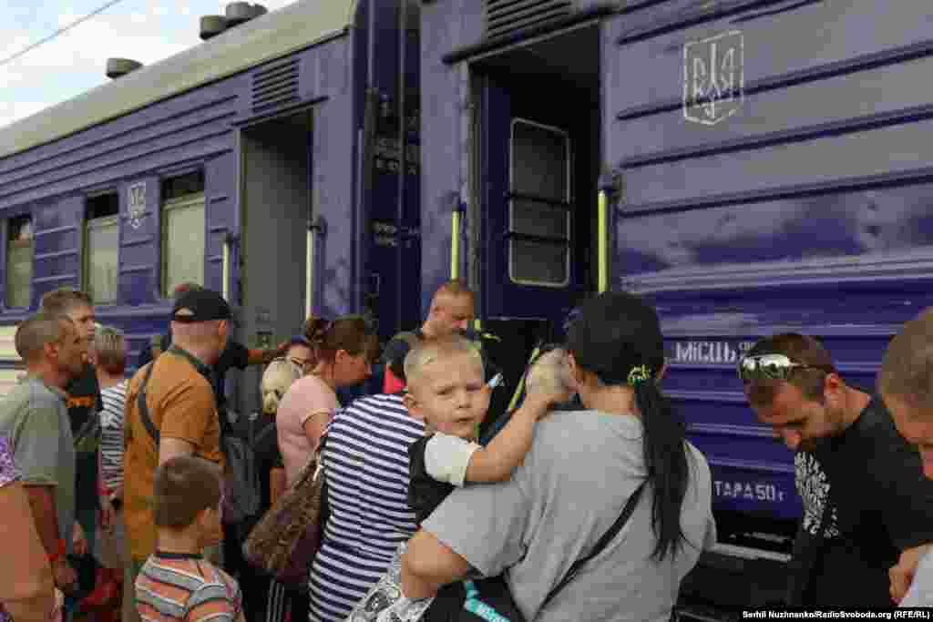 Матір тримає на руках дитину перед посадкою&nbsp; в евакуаційний потяг. 21 серпня Міністерство реінтеграції ТОТ України запровадило примусову евакуацію дітей із батьками з&nbsp;Покровського району Донеччини саме через просування російських військ в цьому районі