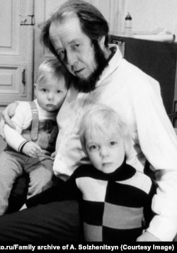 Aleksandr Solzhenitsyn with his sons Ignat (left) and Yermolai in their central Moscow apartment in December 1973. The KGB entered the apartment two months later through the door in the background.