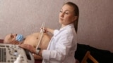 A doctor from the Sakhalin region of Russia works at a hospital in the Russian-occupied territory of Ukraine's Donetsk region. Russian President Vladimir Putin ordered that doctors taking part in a government program to encourage physicians to work in rural Russia receive a onetime 2 million ruble ($21,500) bonus for working in the Donetsk, Kherson, Luhansk, and Zaporizhzhya regions.