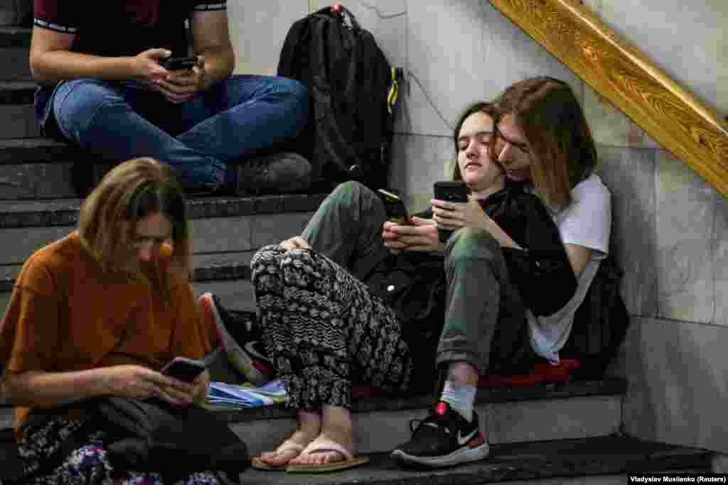 People take cover inside a Kyiv metro station during a Russian missile and drone strike on August 26.&nbsp;